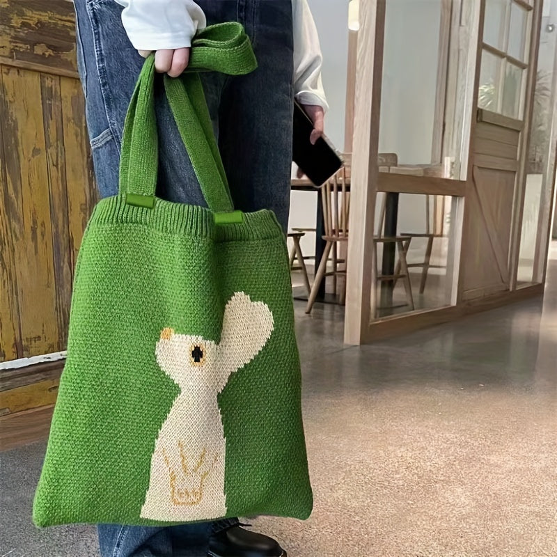 Green knitted rabbit tote bag with looking-up rabbit design shown as a portable shoulder shopping bag